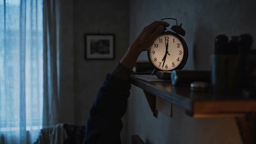 Shot 01 as rendered: the hand, the clock, the cold blue quiet