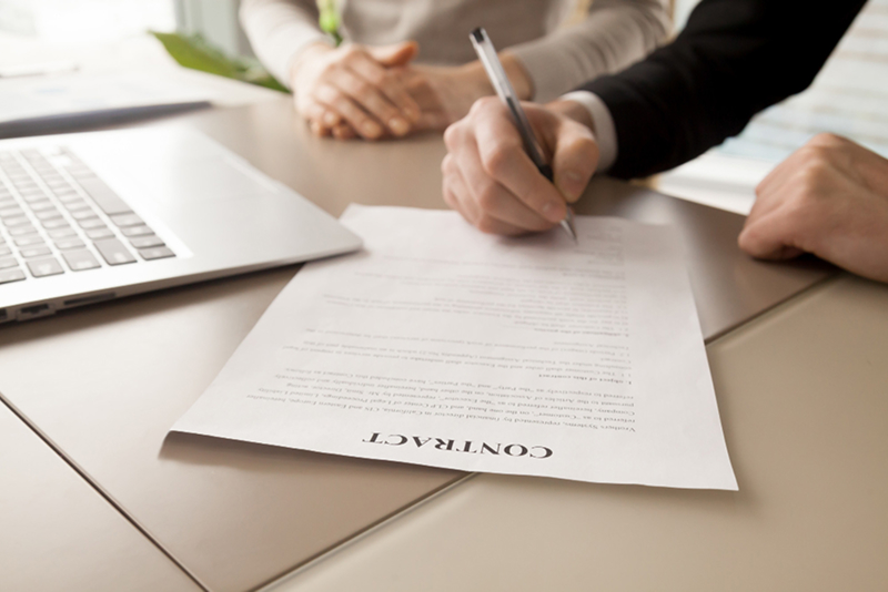 Contract signing meeting laptop business agreement document