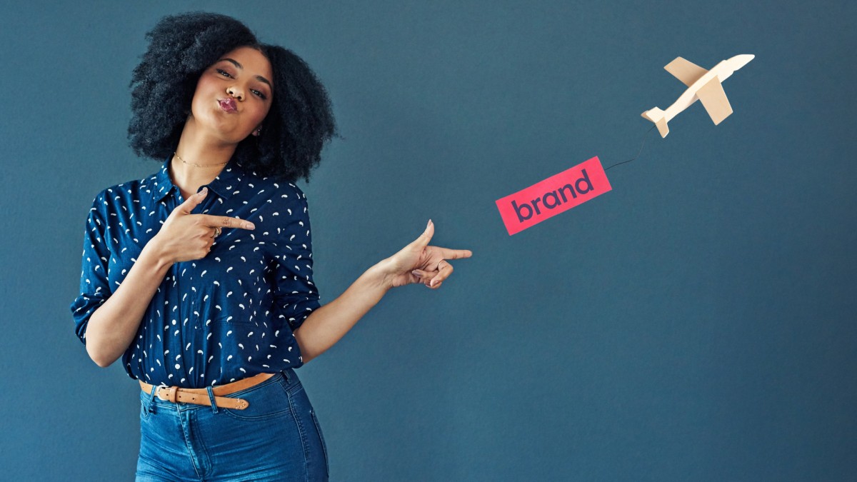 a girl pointing towards brand